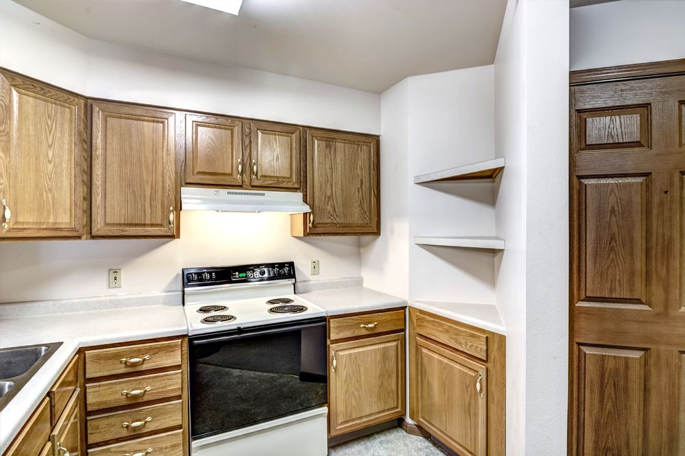 kitchen stove and brown cabinets
