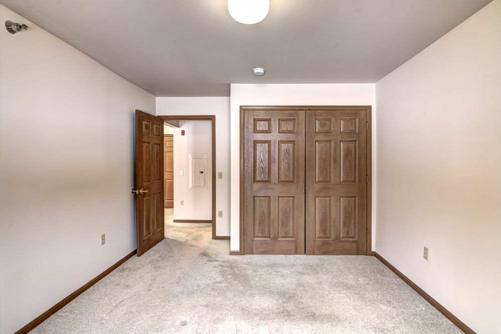 bedroom facing door and closet