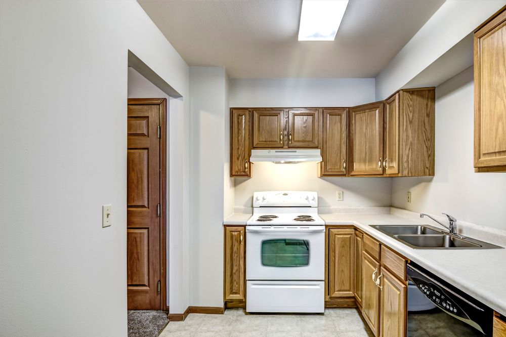 kitchen facing stove with brown cabinets