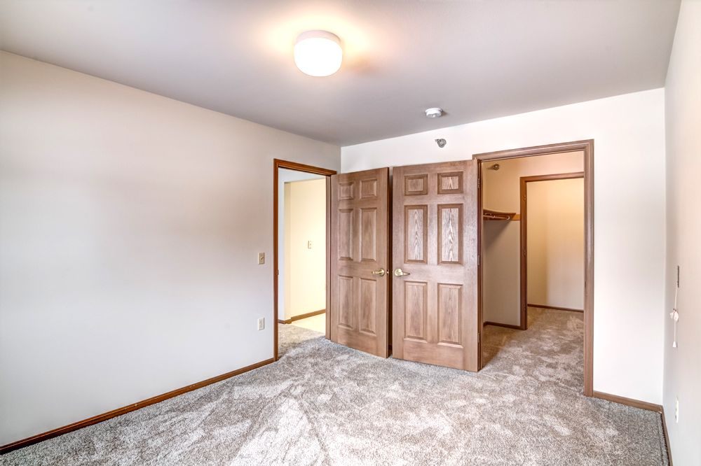 bedroom facing door and closet